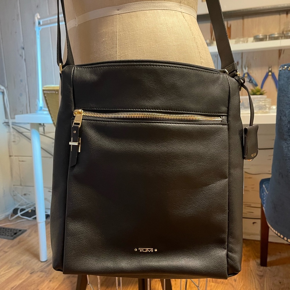 Brand new never been used  Tumi black  leather crossbody handbag.
